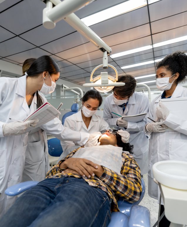 Students From Dental School Examining Patient