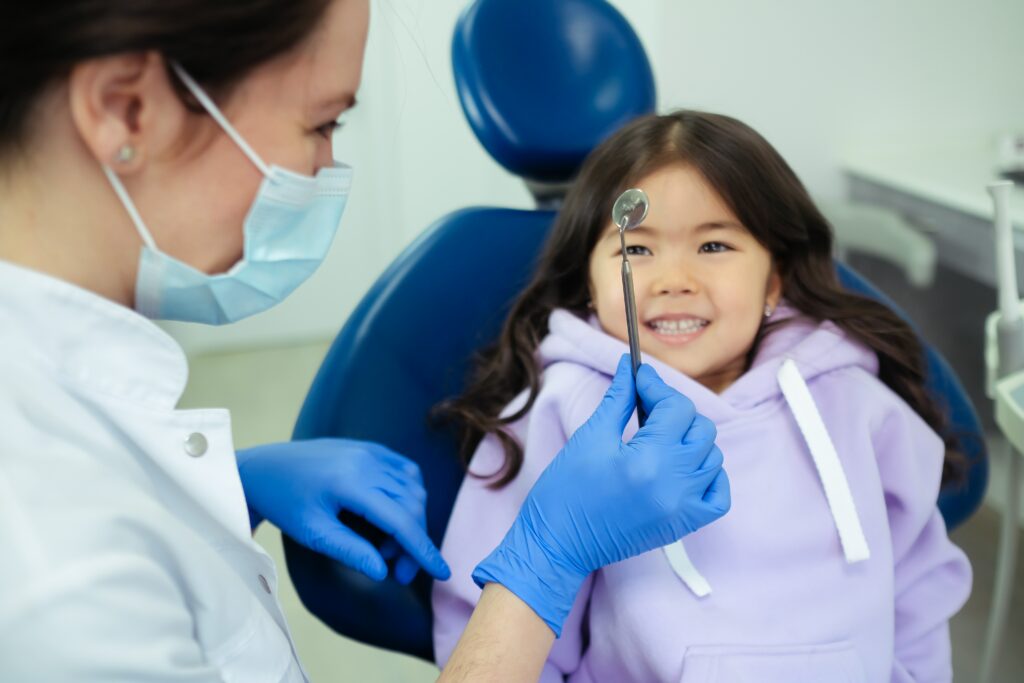 Dentist explaining equipment to a child.